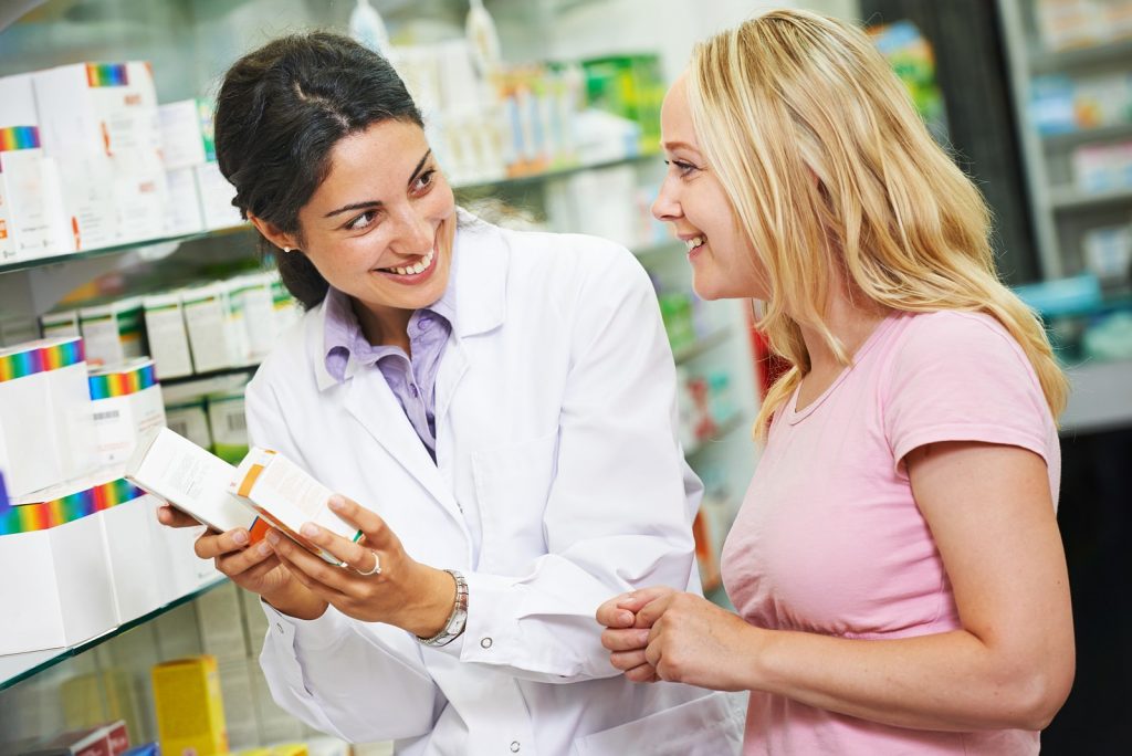 Pharmacist serving customer in expanded scope of practice