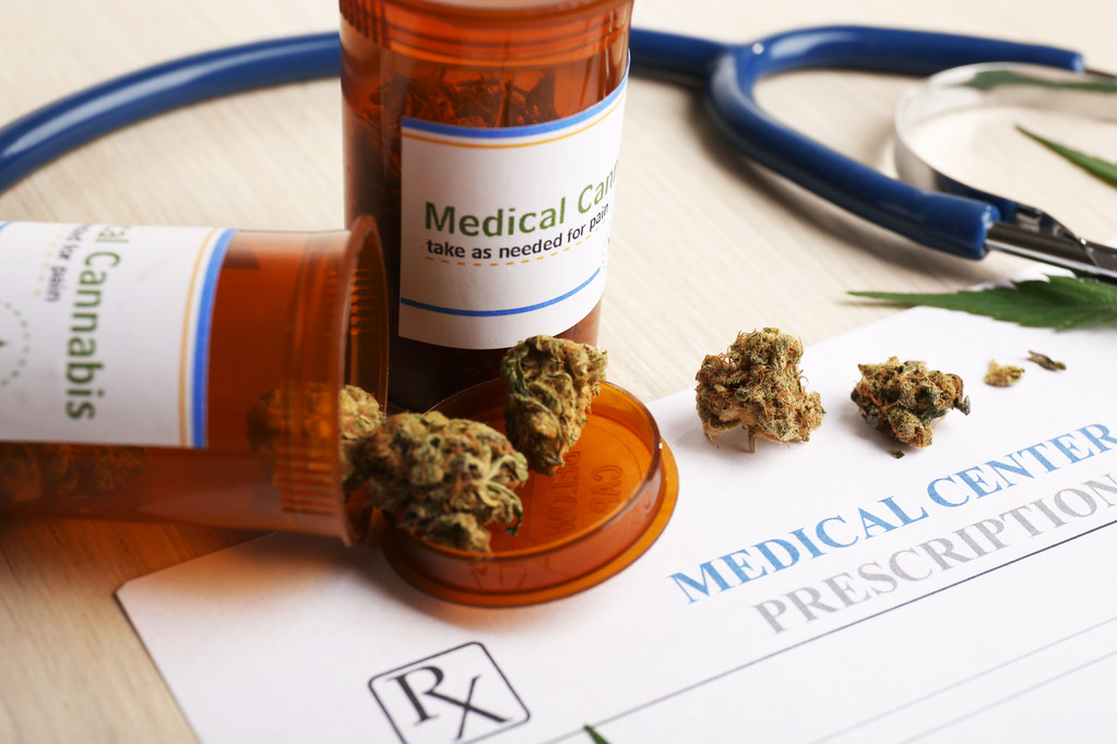 Medical prescription with dry cannabis on table