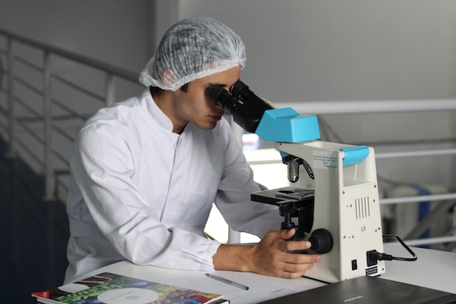 Man in lab using microscope